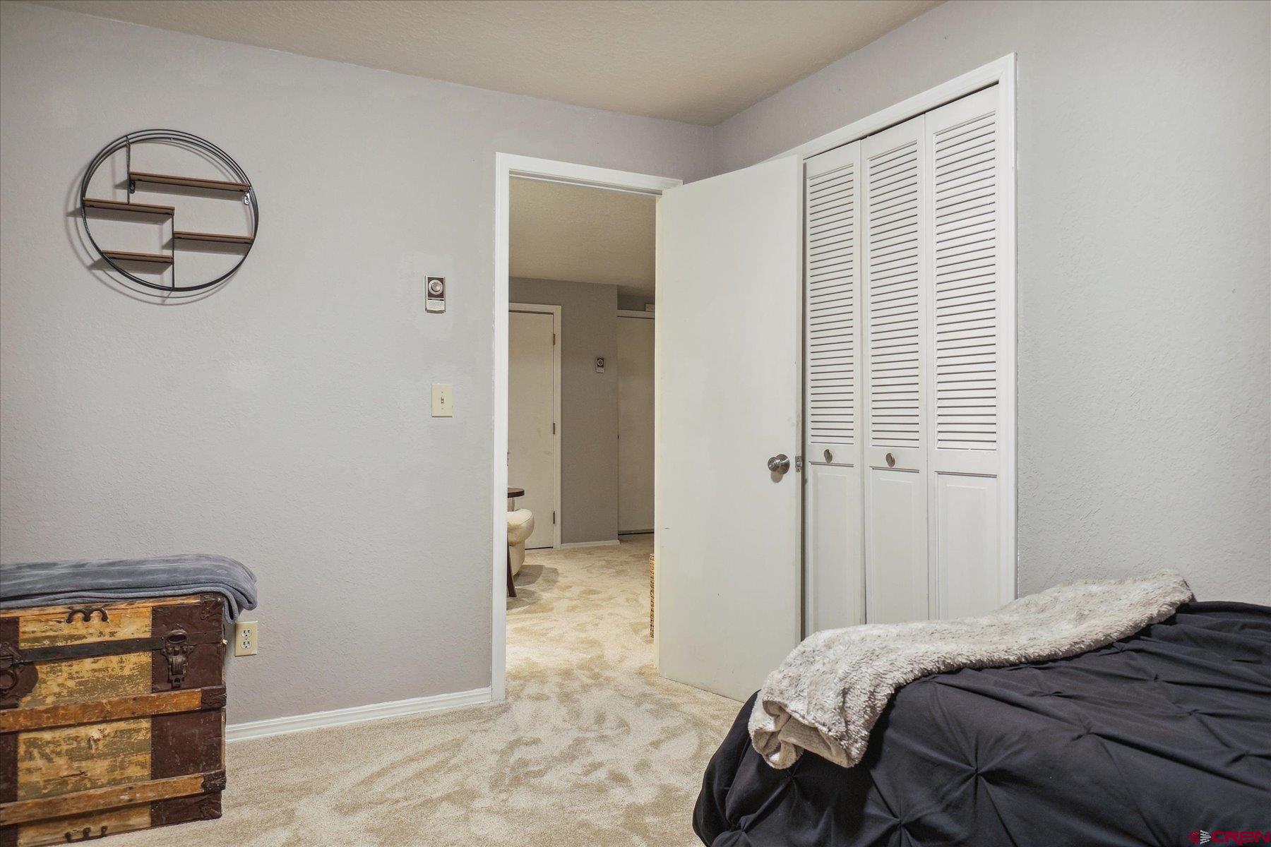 202 Pine Ridge Loop Durango, CO 81301 - Photo 26 of 33 a bedroom with a bed and a chandelier