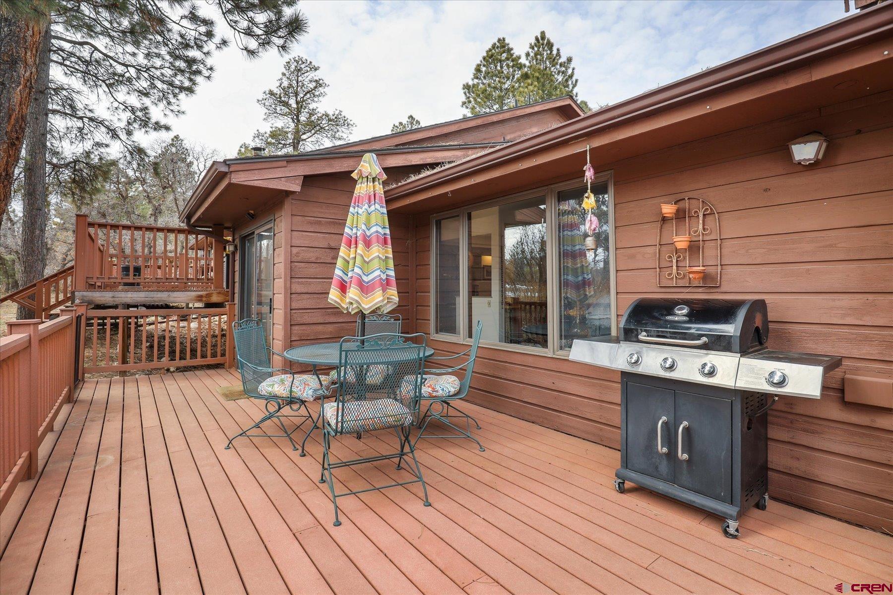 202 Pine Ridge Loop Durango, CO 81301 - Photo 32 of 33 a view of a deck with wooden floor and furniture