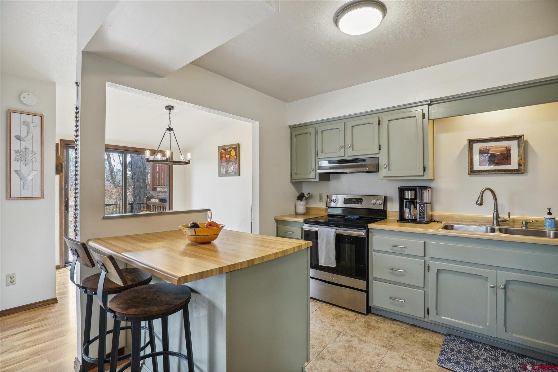 202 Pine Ridge Loop Durango, CO 81301 - Photo 10 of 33 a kitchen with stainless steel appliances granite countertop a stove top oven a sink dishwasher and cabinets with wooden floor