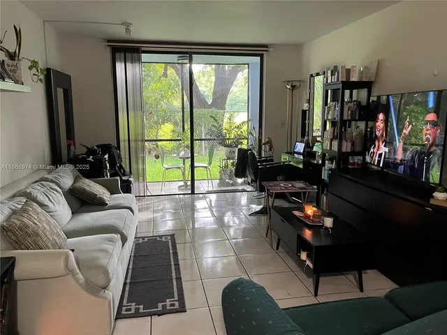 a living room with furniture and a floor to ceiling window