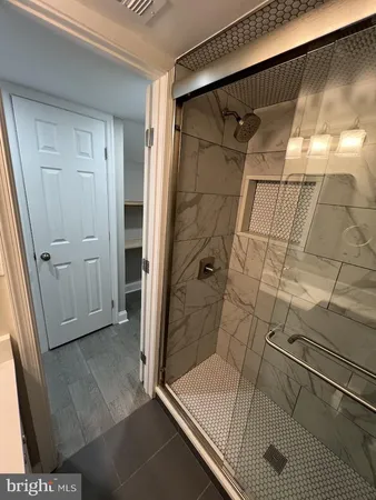a bathroom with a toilet and a shower