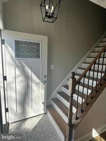 a view of staircase with white walls and a window