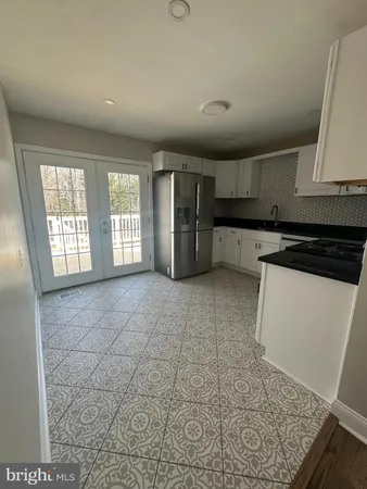 a view of a kitchen with a sink and dishwasher stove top oven with wooden floor
