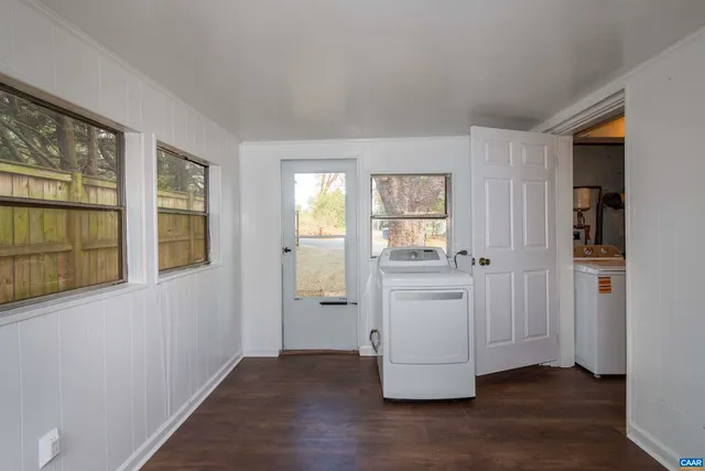 an empty room with a window and a lamp