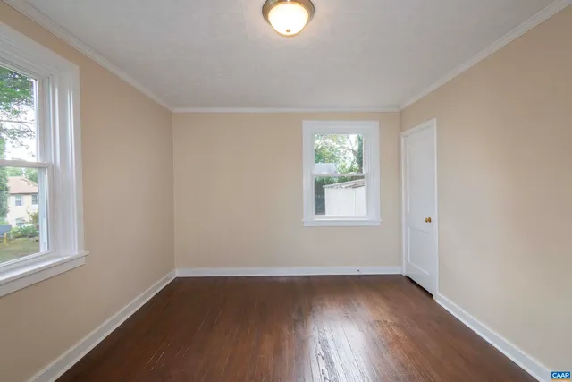 an empty room with windows and closet