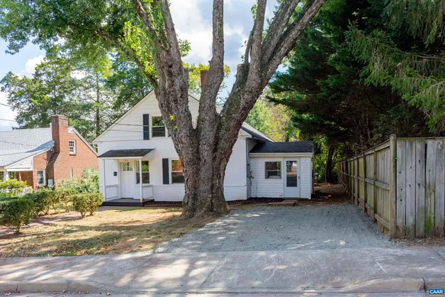 a view of a yard with large trees