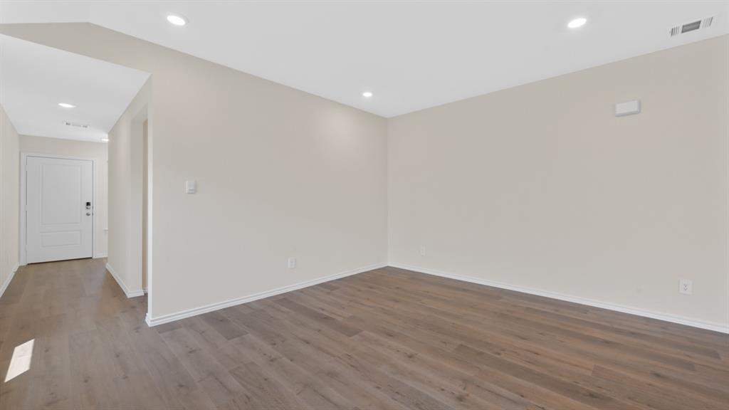 657 Glee Stem Road Lavon, TX 75166 - Photo 12 of 26 Spacious room with wood-finish flooring, recessed lighting, neutral paint, and white baseboards