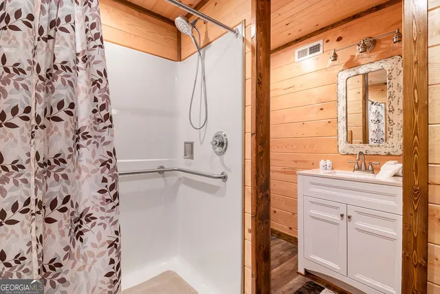 a bathroom with a shower curtain and a sink
