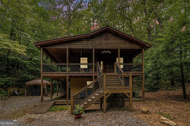 a view of house with wooden deck and furniture