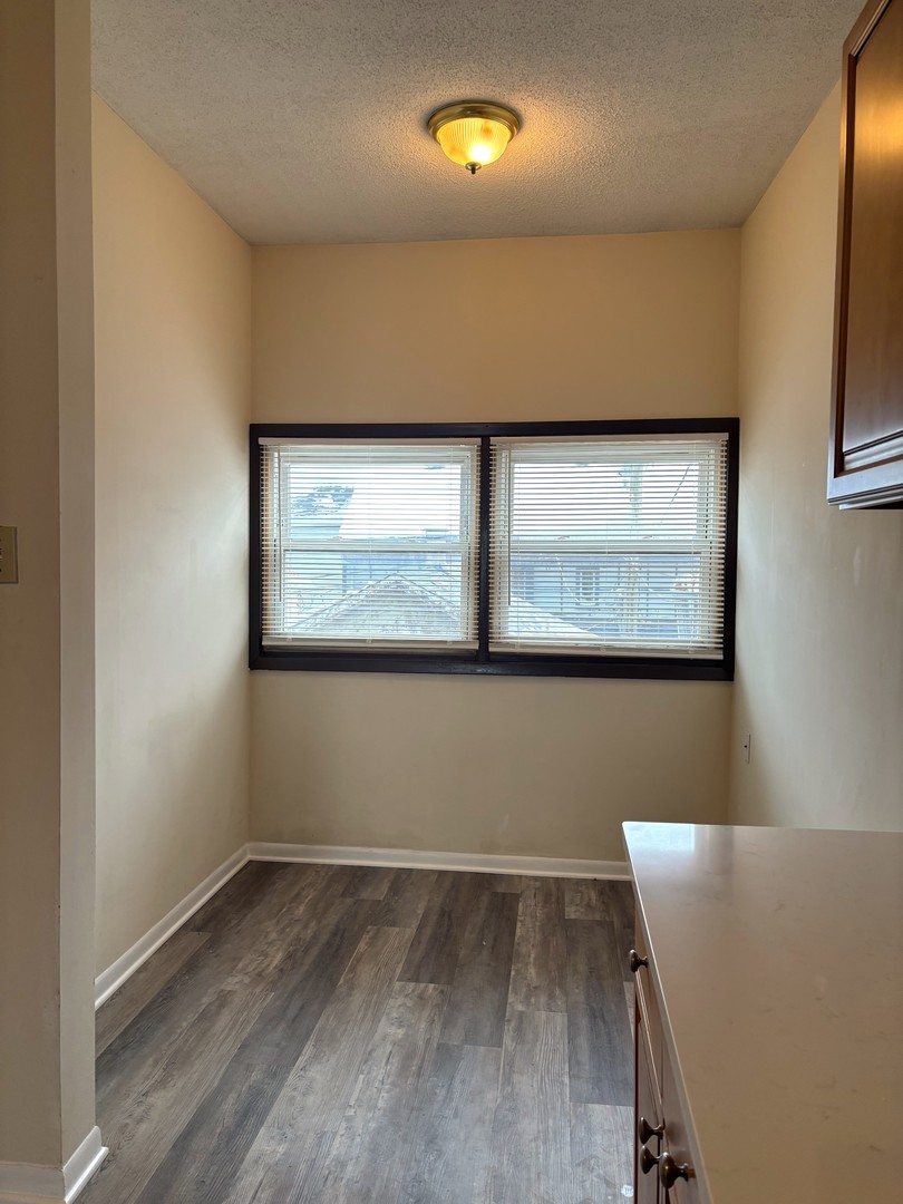 3003 North Ashland Avenue, Unit 3 Chicago, IL 60657 - Photo 11 of 14 a view of room with window and wooden floor
