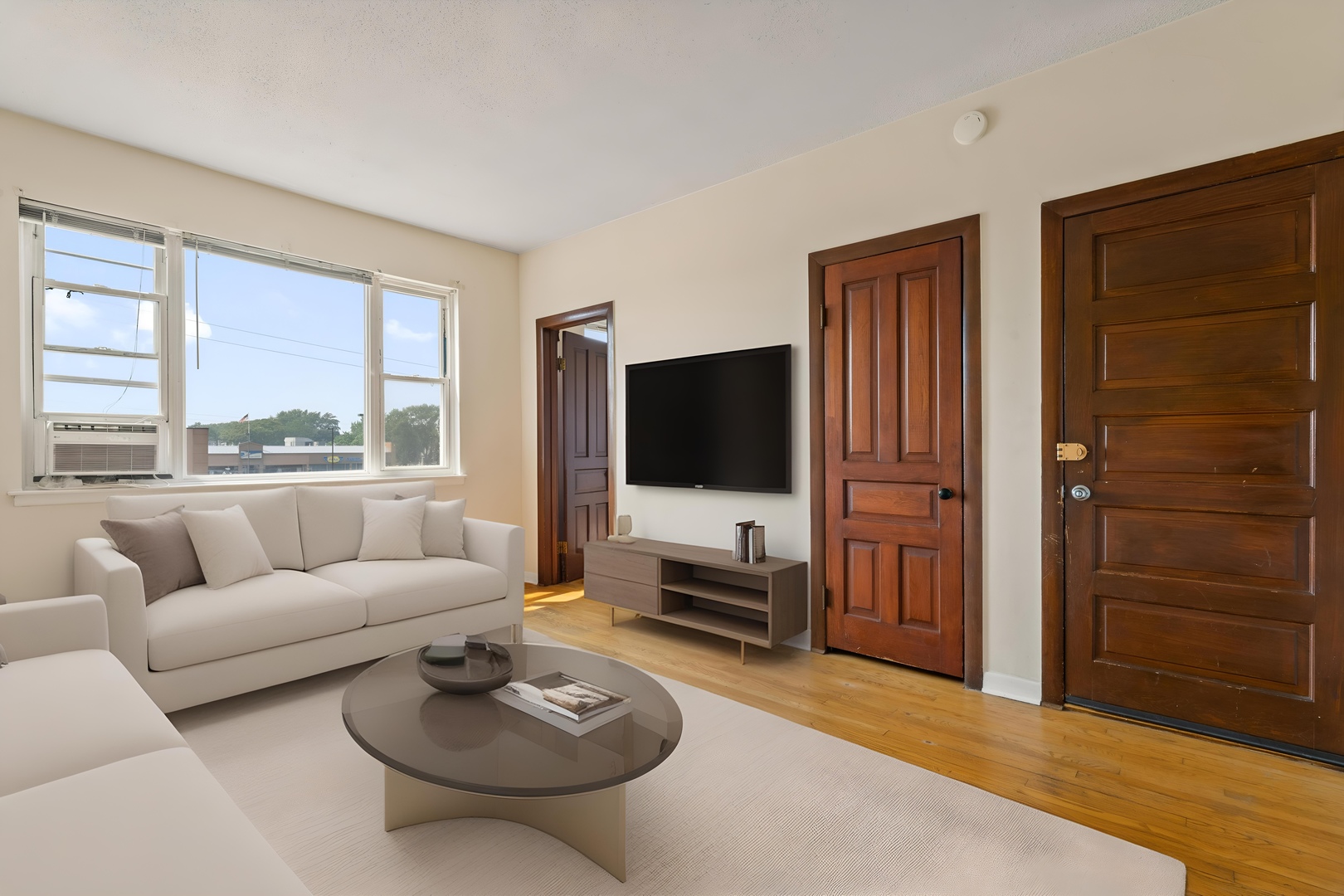 3003 North Ashland Avenue, Unit 3 Chicago, IL 60657 - Photo 2 of 14 a living room with furniture a flat screen tv and a large window
