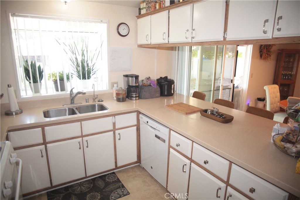 27502 Amethyst Way Castaic, CA 91384 - Photo 7 of 23 a kitchen with sink cabinets and window