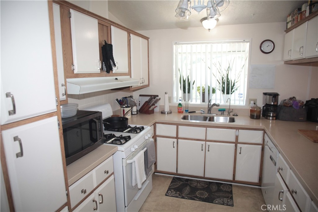27502 Amethyst Way Castaic, CA 91384 - Photo 8 of 23 a kitchen with a sink stove and cabinets