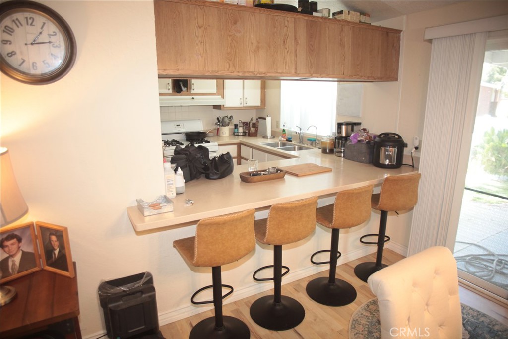 27502 Amethyst Way Castaic, CA 91384 - Photo 9 of 23 a kitchen with a sink a stove and a refrigerator