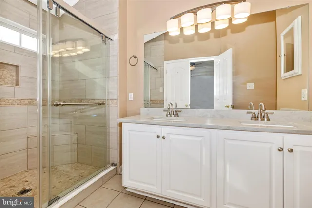 a bathroom with a shower sink and mirror