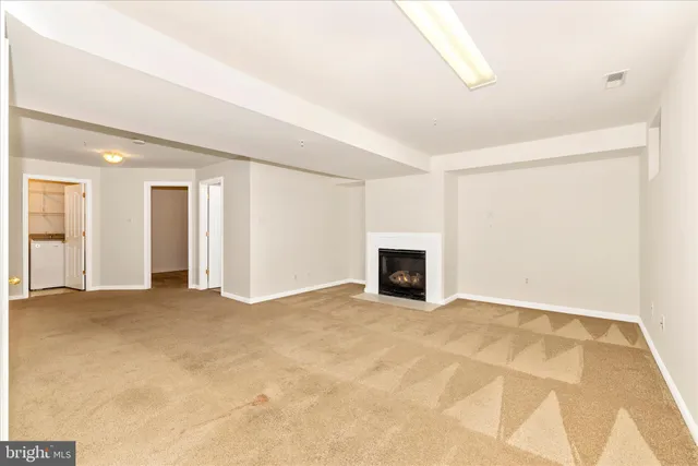 a view of an empty room with a fireplace
