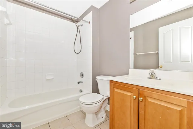 a bathroom with a granite countertop toilet sink and shower