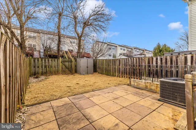 a backyard of a house with a bench
