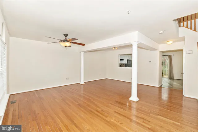a view of a room with wooden floor