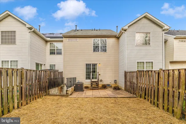 a view of a house with wooden fence