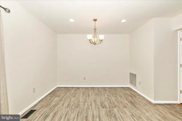 a room view with wooden floor and white walls