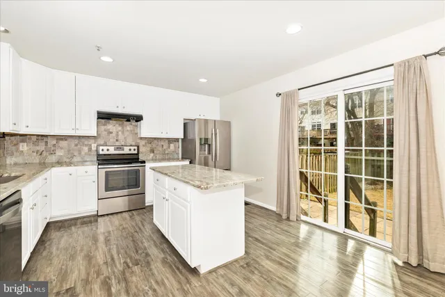 a kitchen with a stove a sink and a refrigerator