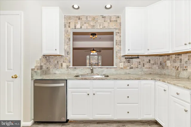 a sink with white cabinets