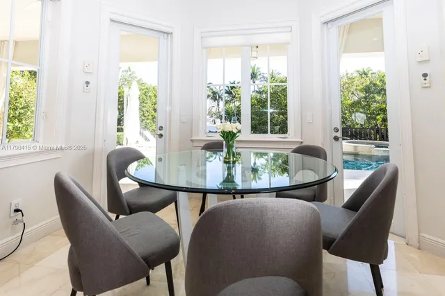 a dining room with furniture and a window