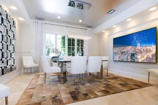 a view of a dining room with furniture a rug and wooden floor