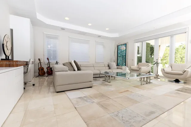a living room with furniture and large windows