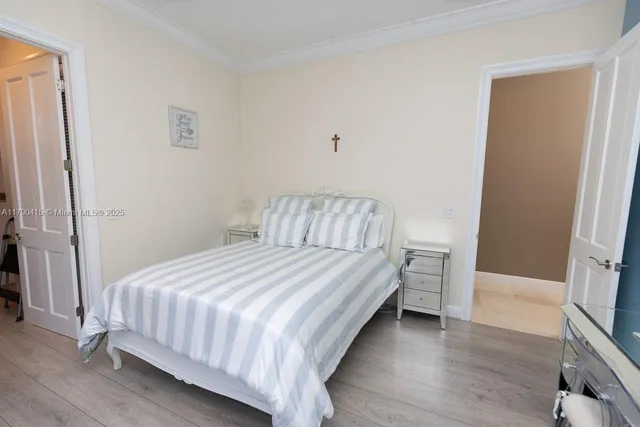 a bedroom with a bed and a mirror