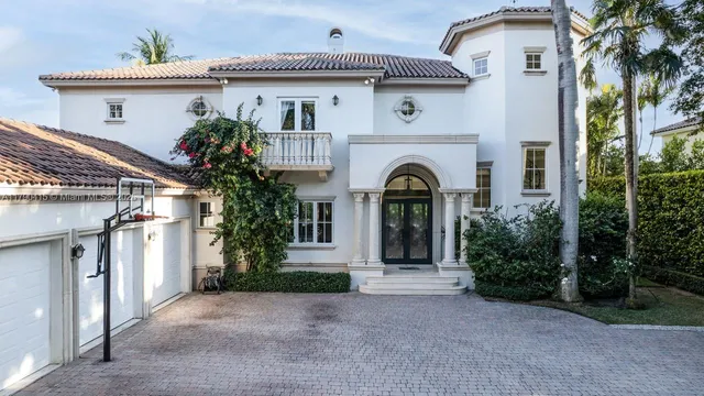 a front view of a house with plants