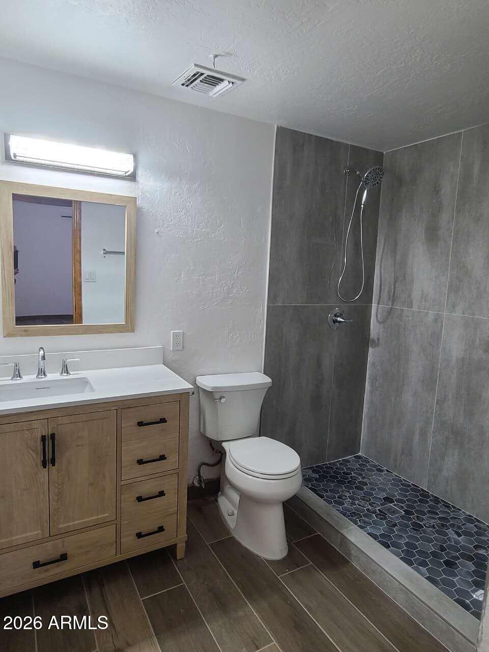 3702 East Thunderbird Road Phoenix, AZ 85032 - Photo 15 of 23 a bathroom with a sink toilet a mirror and shower