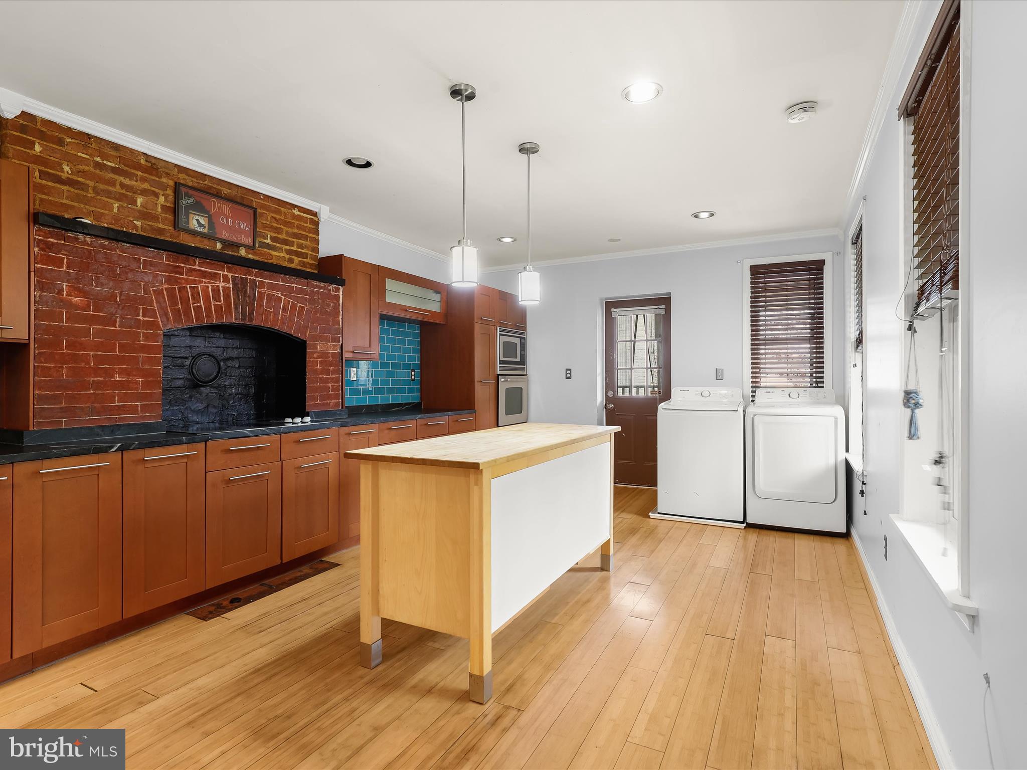 55 South Fulton Avenue Baltimore, MD 21223 - Photo 8 of 55 a large kitchen with stainless steel appliances granite countertop a stove and a wooden floors