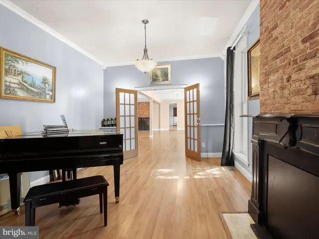 a large kitchen with stainless steel appliances granite countertop a stove and a wooden floors