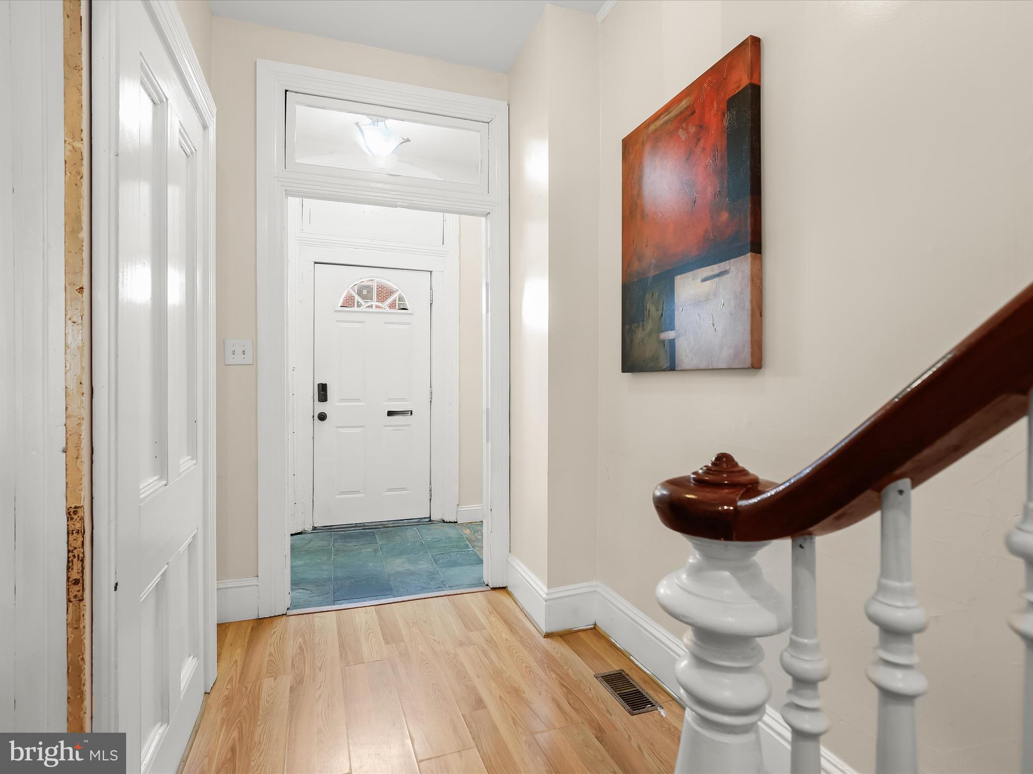 55 South Fulton Avenue Baltimore, MD 21223 - Photo 2 of 55 a view of a hallway with wooden floor and a bathroom