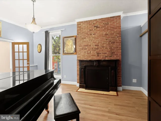 a kitchen that has a sink a microwave oven a stove and white cabinets
