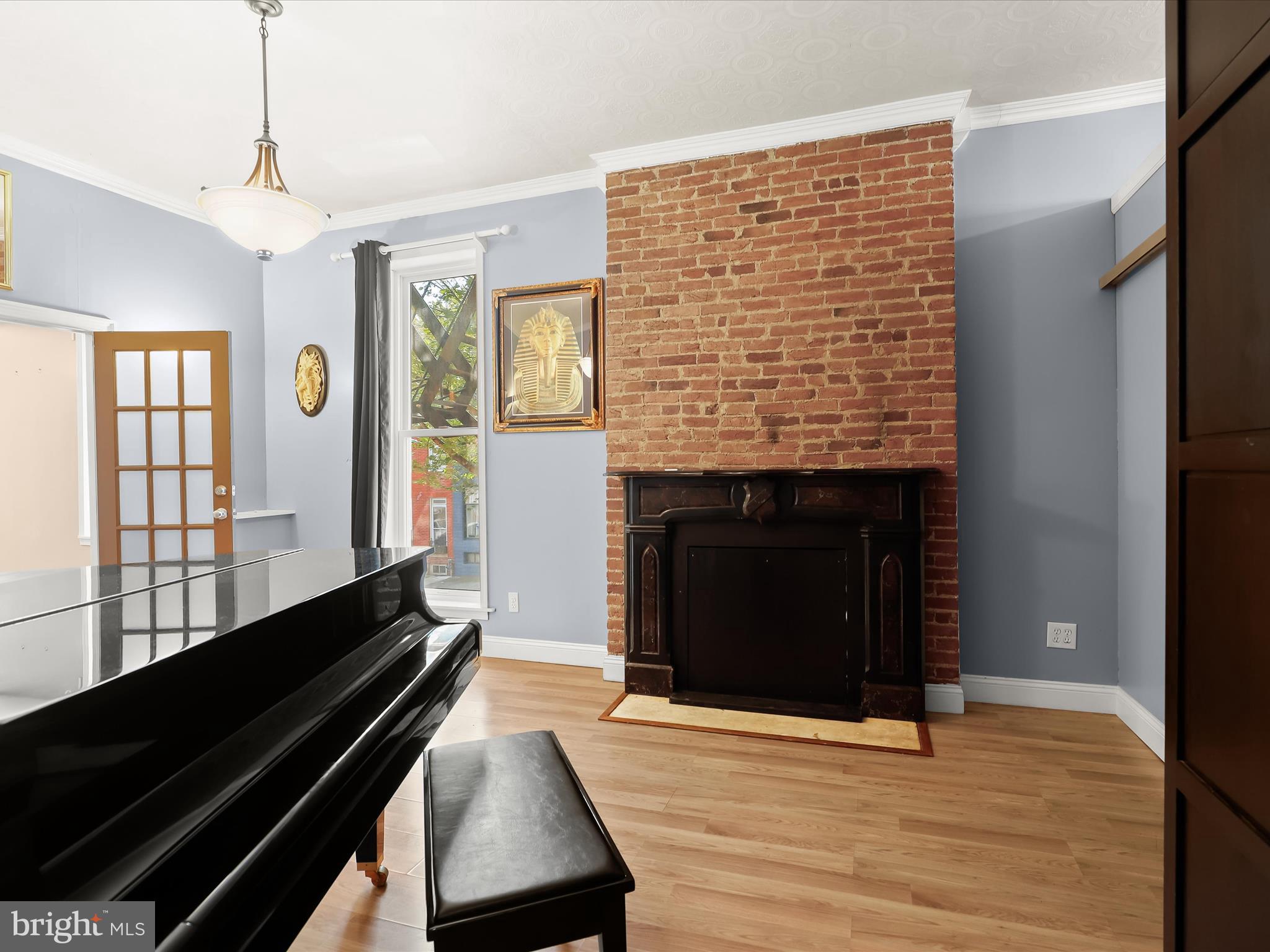 55 South Fulton Avenue Baltimore, MD 21223 - Photo 15 of 55 a living room with furniture and a fireplace