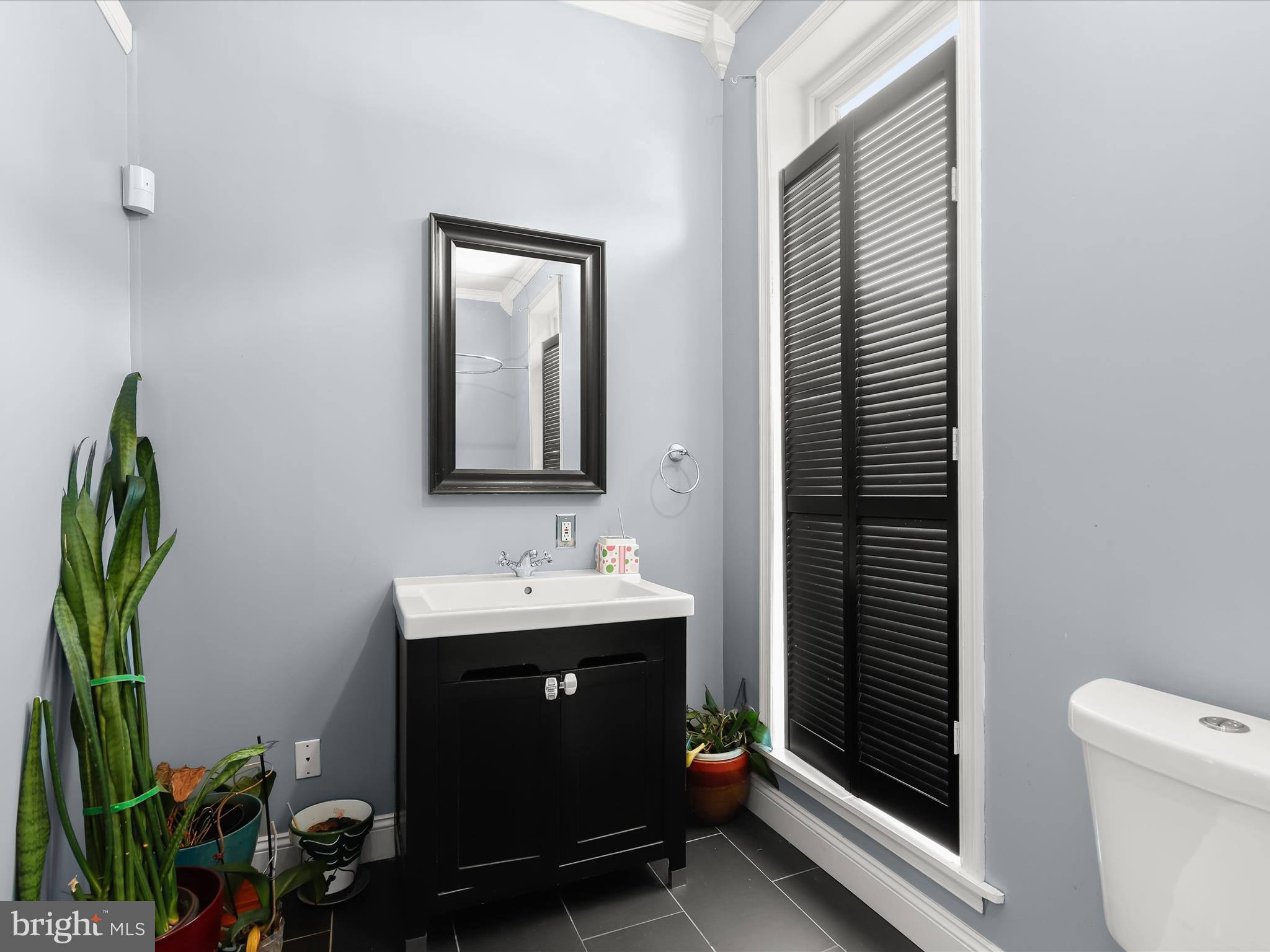 55 South Fulton Avenue Baltimore, MD 21223 - Photo 17 of 55 a bathroom with a toilet a sink and mirror