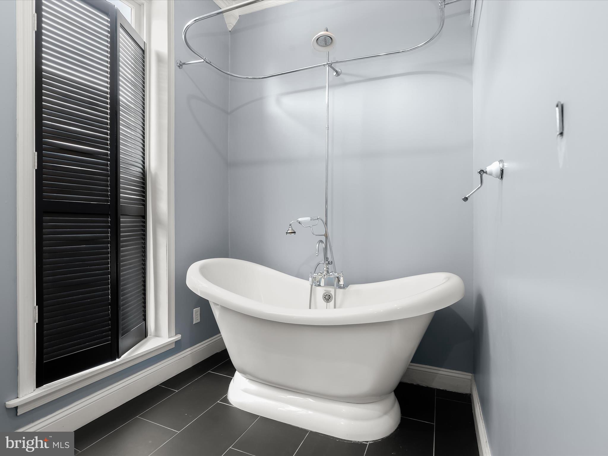 55 South Fulton Avenue Baltimore, MD 21223 - Photo 18 of 55 a white bath tub sitting in a bathroom