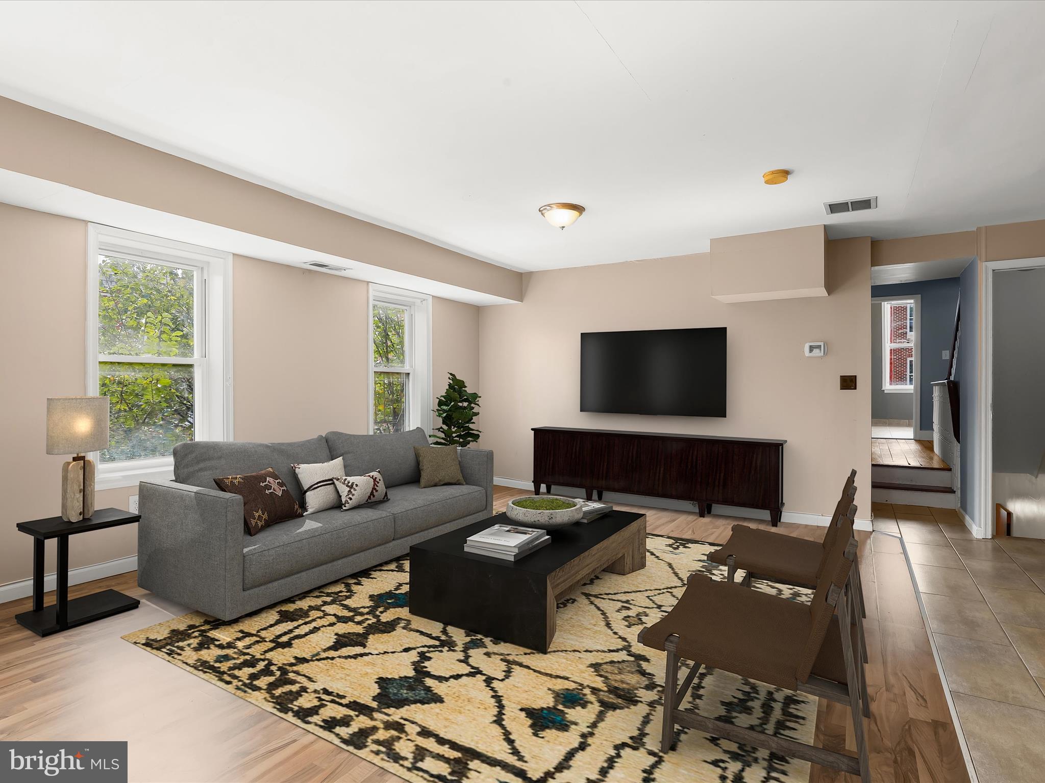 55 South Fulton Avenue Baltimore, MD 21223 - Photo 19 of 55 a living room with furniture and a flat screen tv