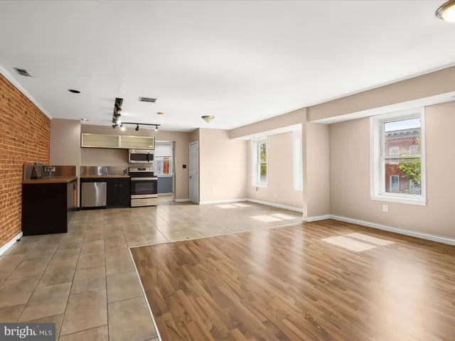 a view of a workspace with furniture and wooden floor