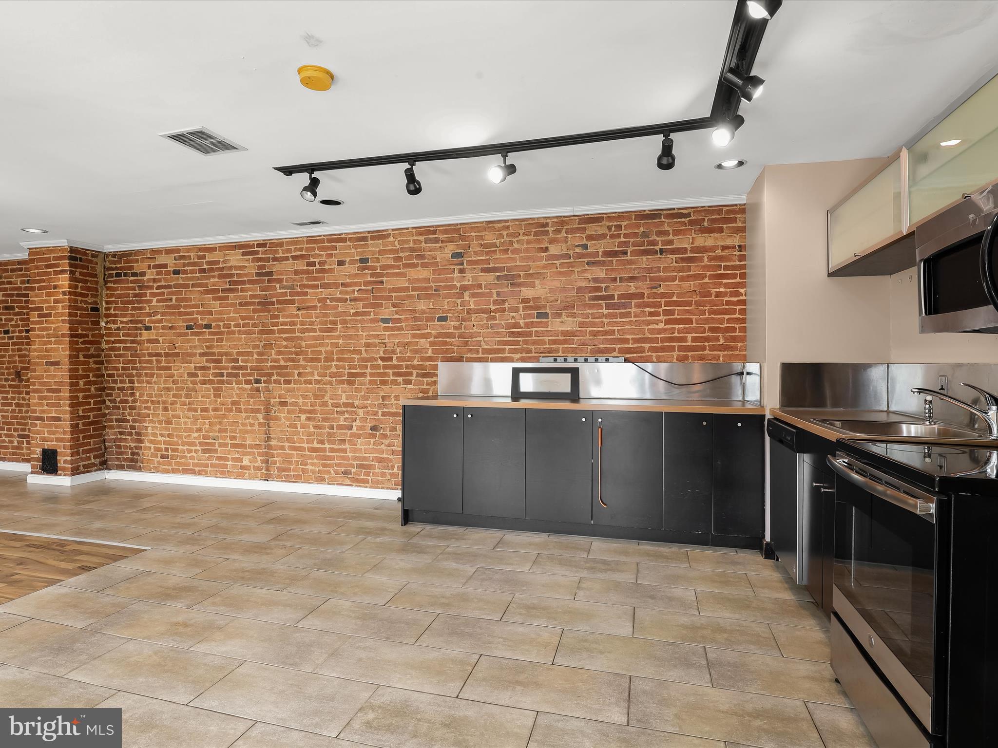 55 South Fulton Avenue Baltimore, MD 21223 - Photo 23 of 55 a kitchen with stainless steel appliances granite countertop a stove a sink and a refrigerator