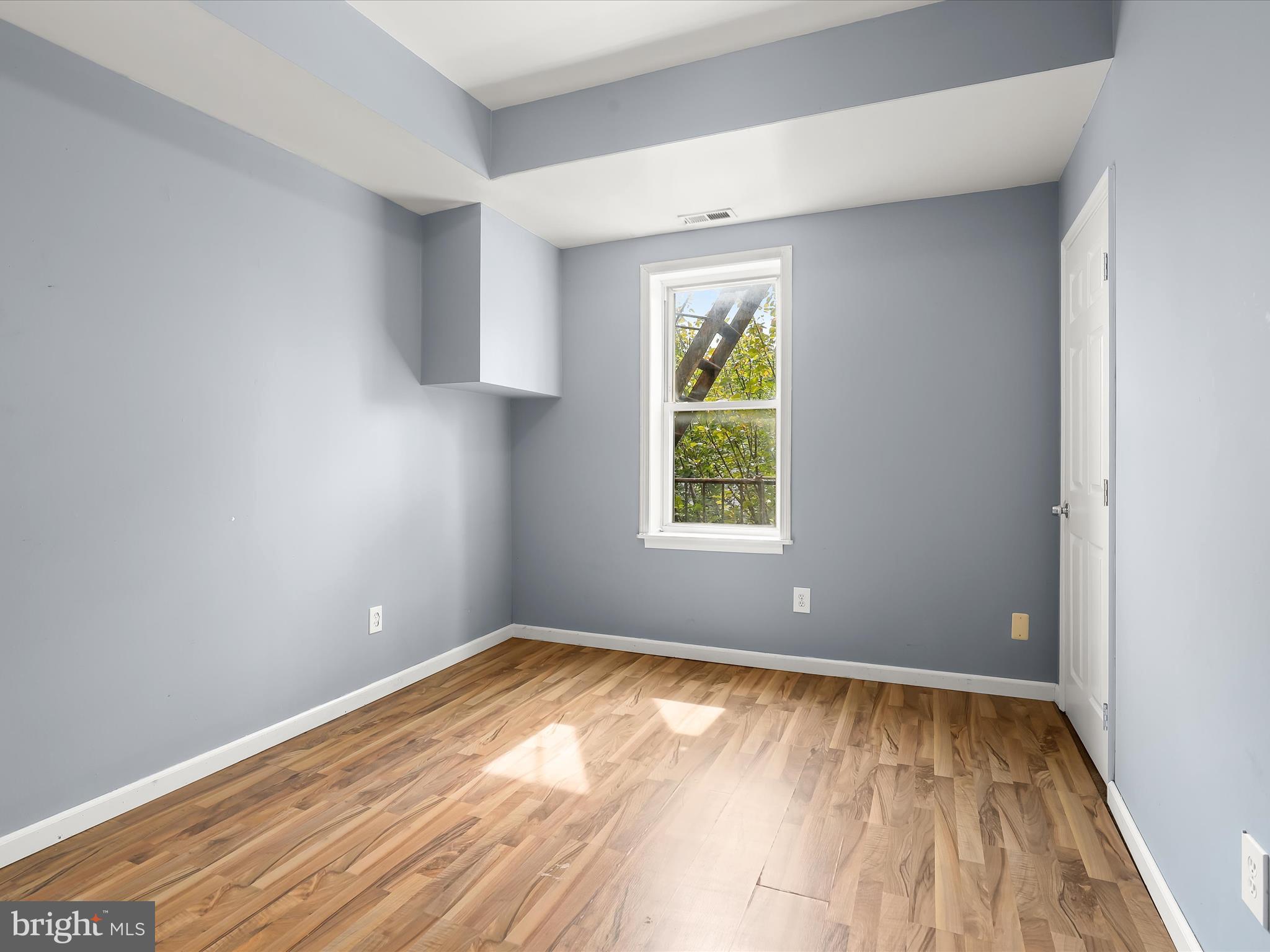55 South Fulton Avenue Baltimore, MD 21223 - Photo 27 of 55 wooden floor in an empty room with a window