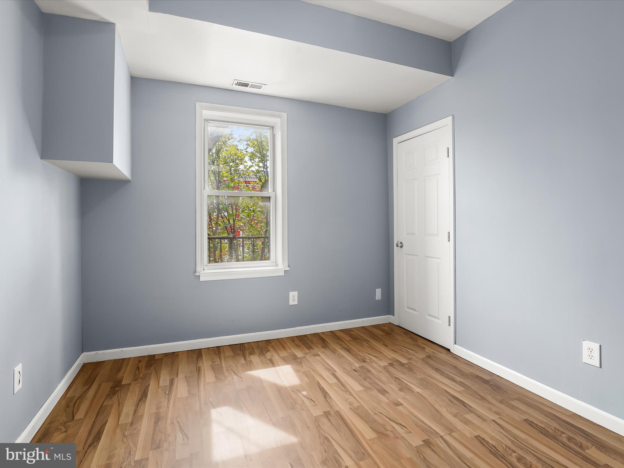 55 South Fulton Avenue Baltimore, MD 21223 - Photo 28 of 55 a view of empty room with wooden floor and fan