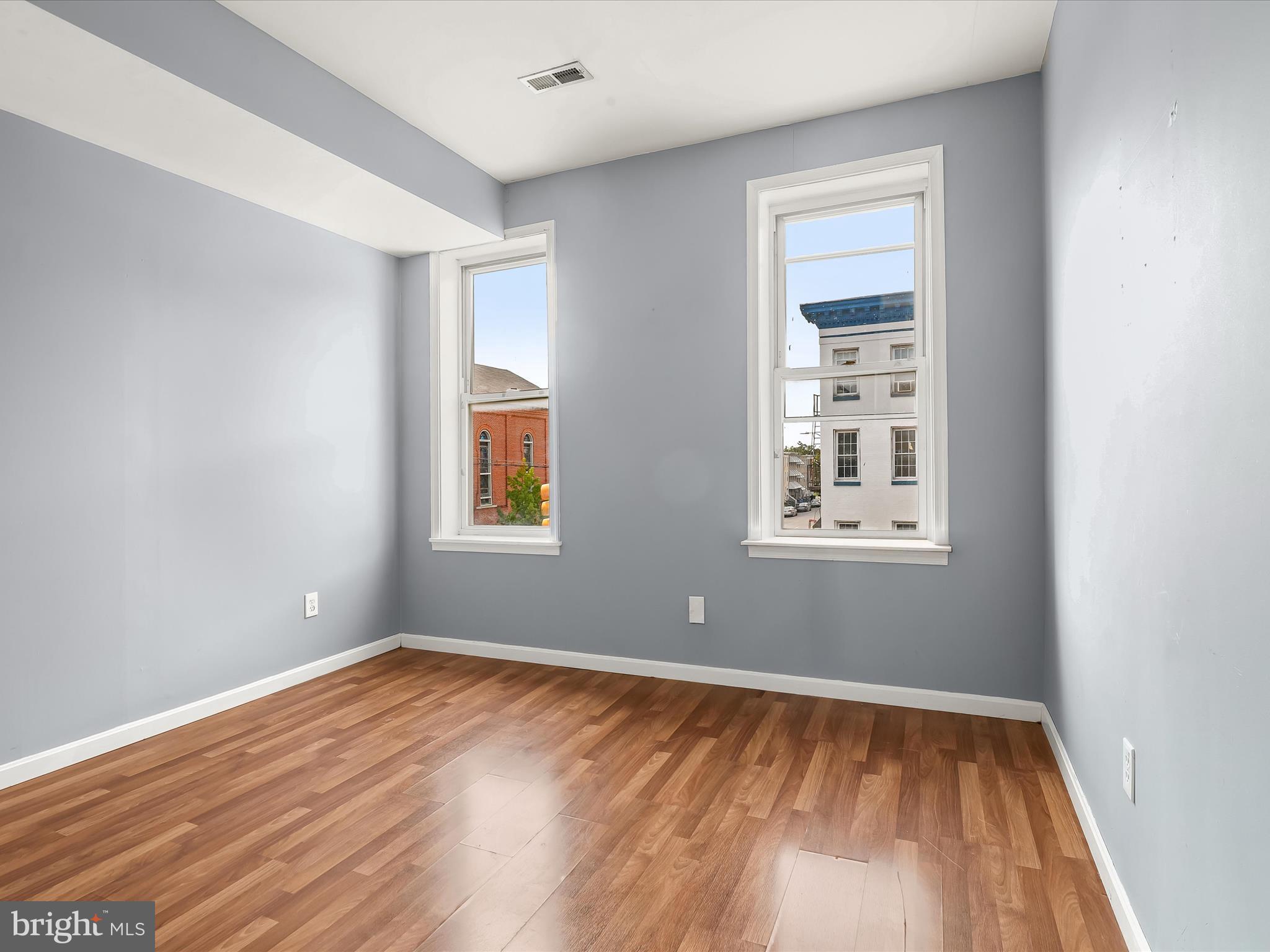 55 South Fulton Avenue Baltimore, MD 21223 - Photo 29 of 55 a view of empty room with wooden floor and fan