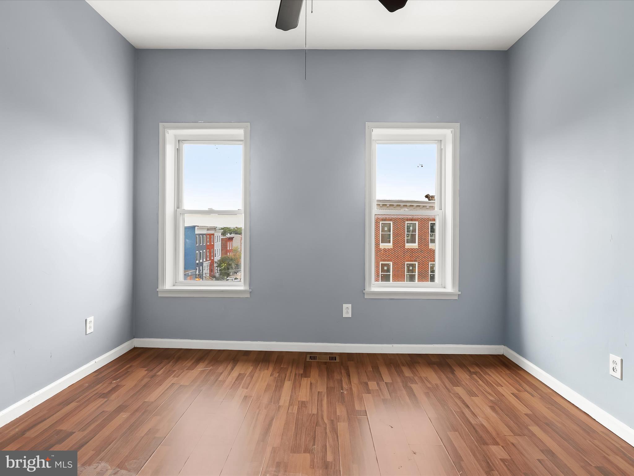 55 South Fulton Avenue Baltimore, MD 21223 - Photo 37 of 55 a view of an empty room with wooden floor and a window