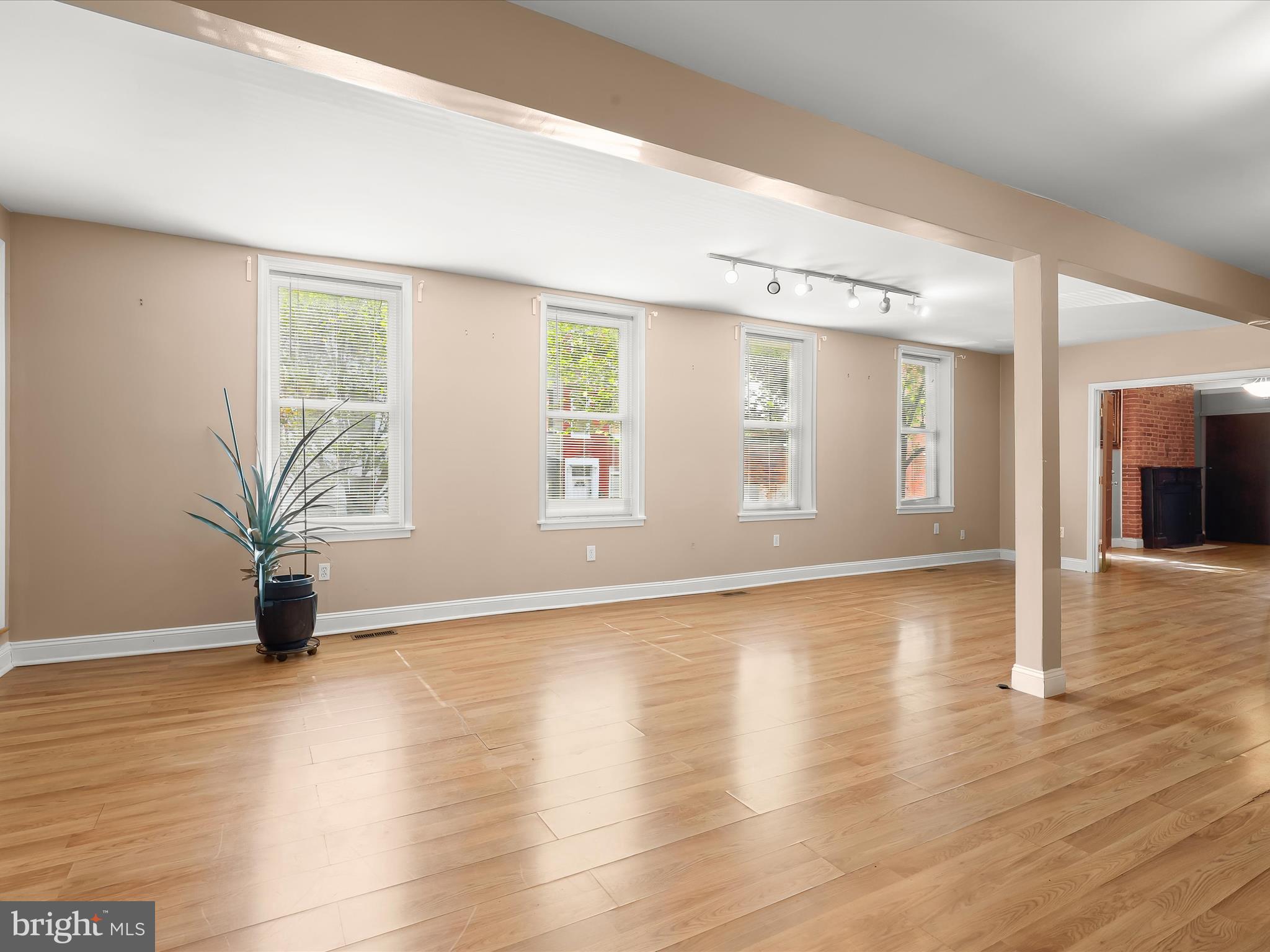 55 South Fulton Avenue Baltimore, MD 21223 - Photo 48 of 55 an empty room with wooden floor and windows