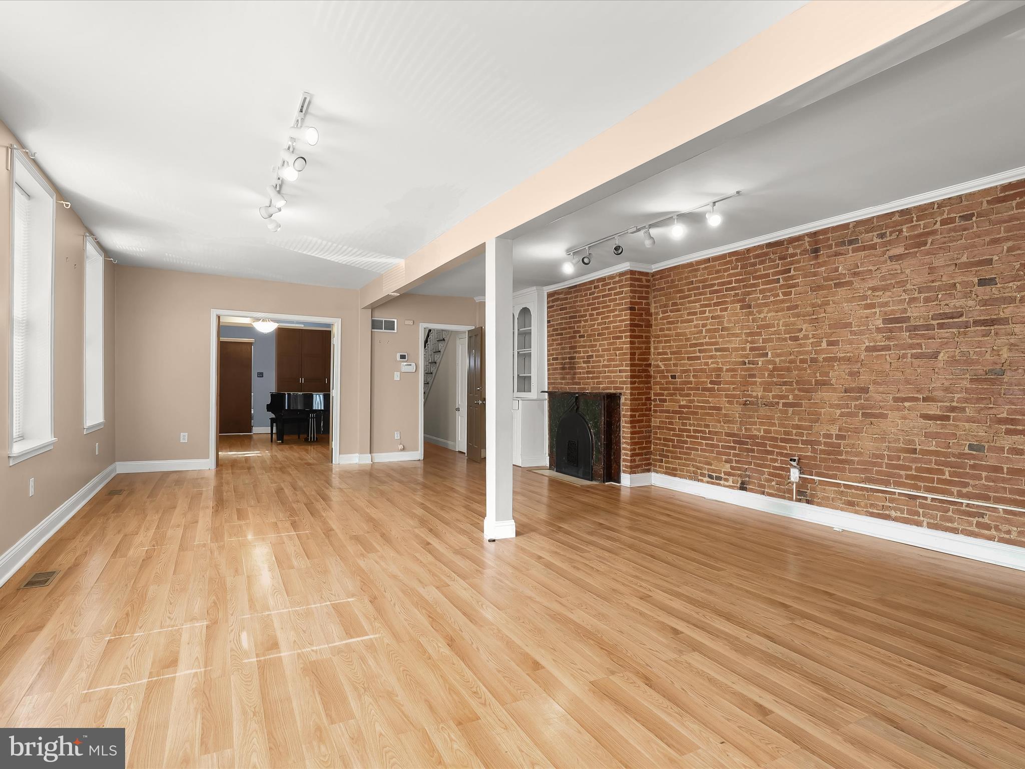 55 South Fulton Avenue Baltimore, MD 21223 - Photo 49 of 55 a view of an empty room with wooden floor and a window