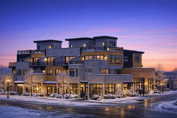 a front view of a building with a yard